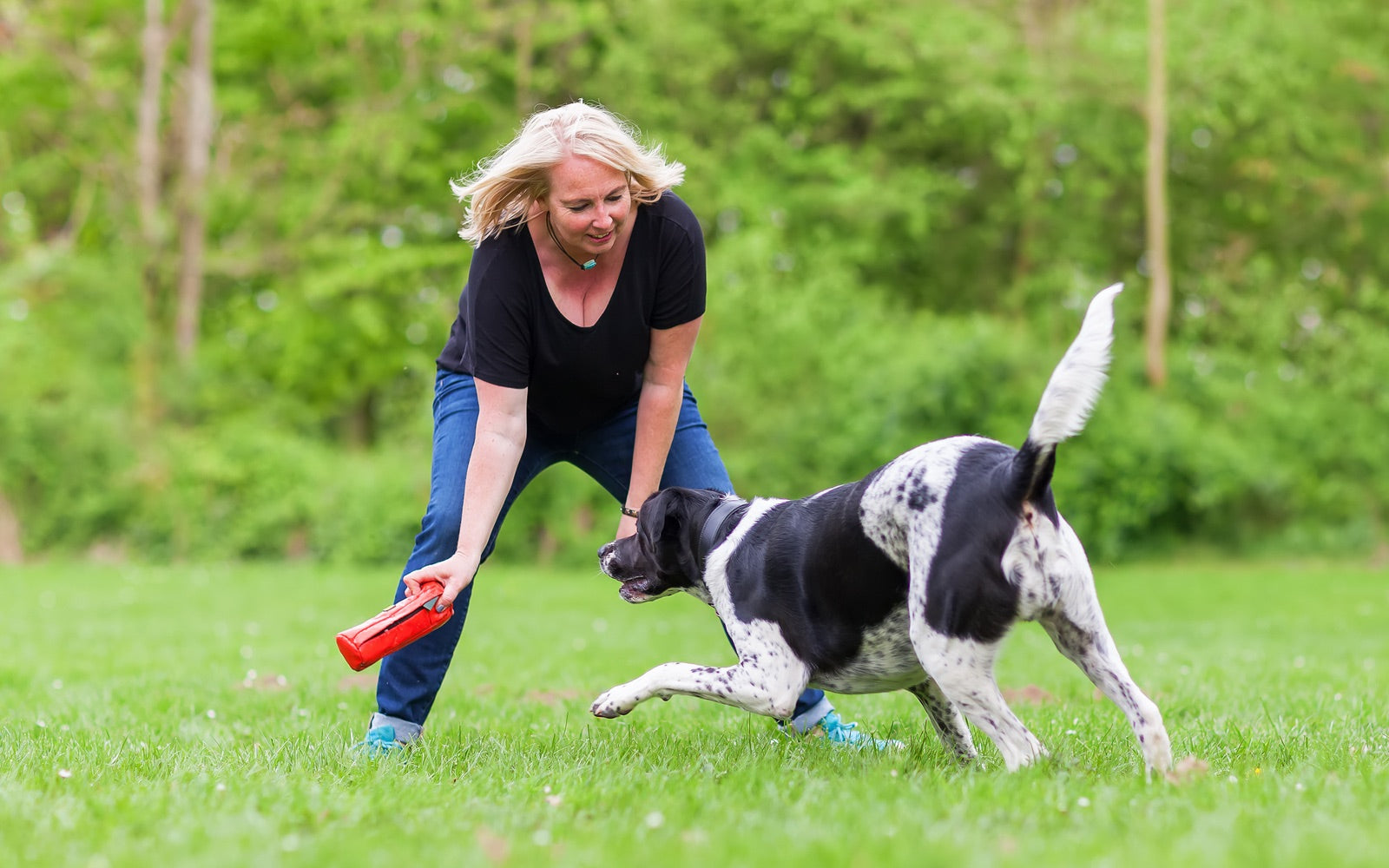 A dog and their person sharing a calm moment outdoors.